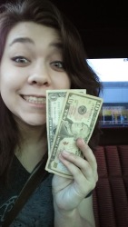 a girl holding up 11 dollars